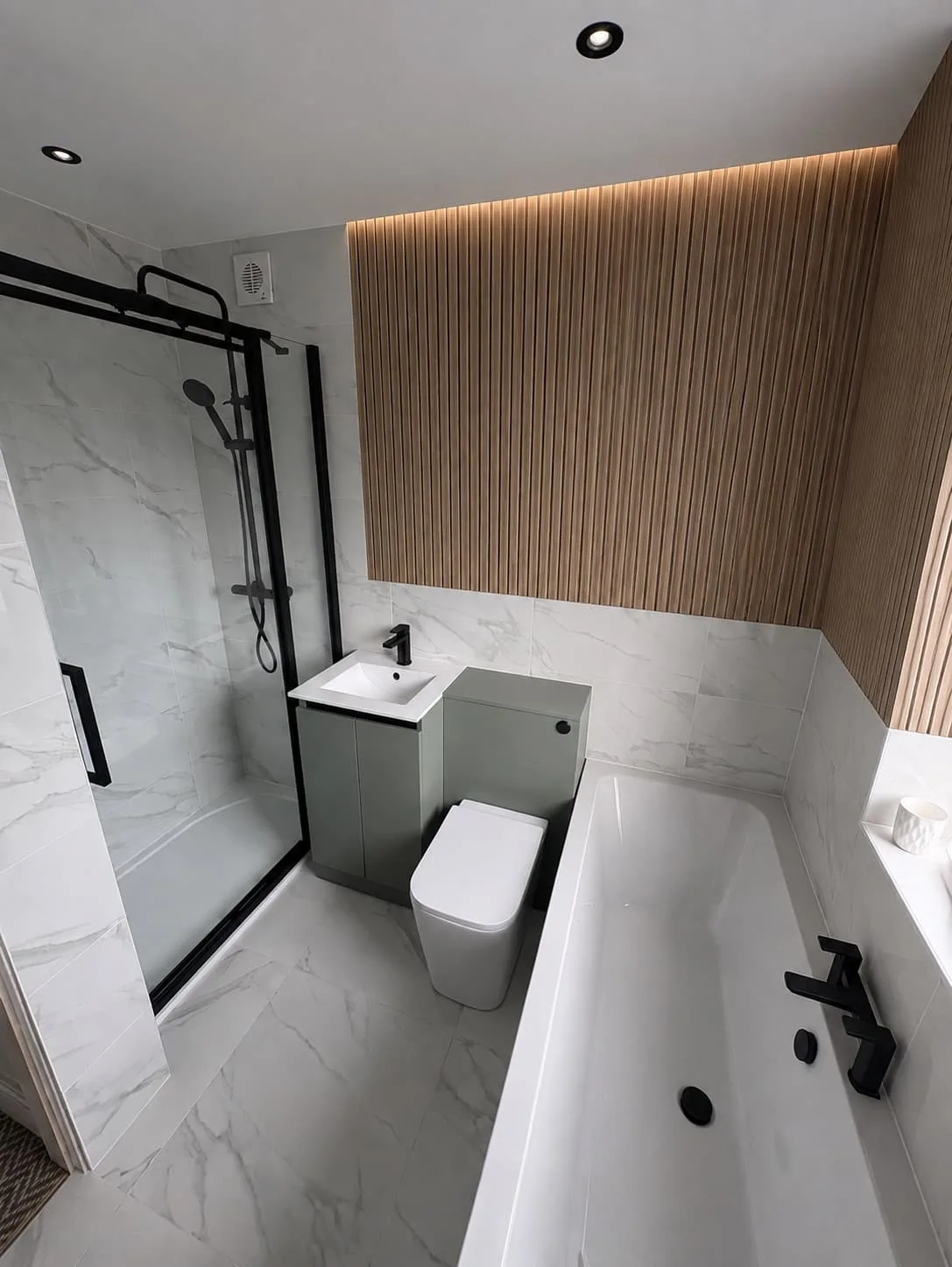 Bathroom with black fittings and wood feature wall